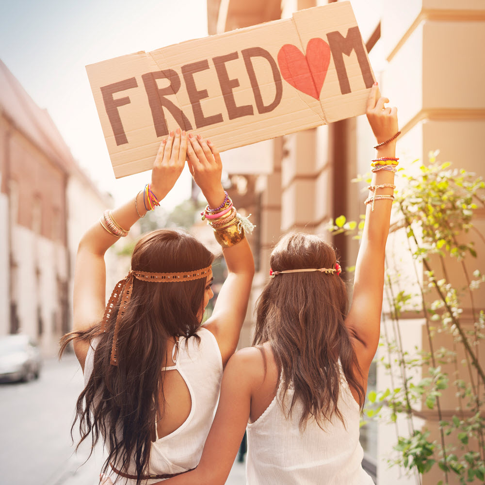 boho girls with sign with text freedom