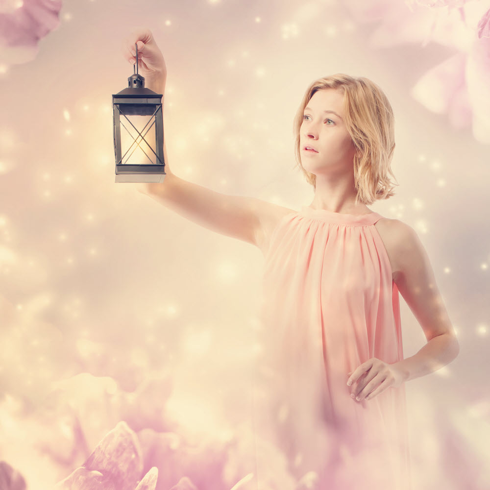 young woman in a pink dress with a lamp in pink abstract flower background