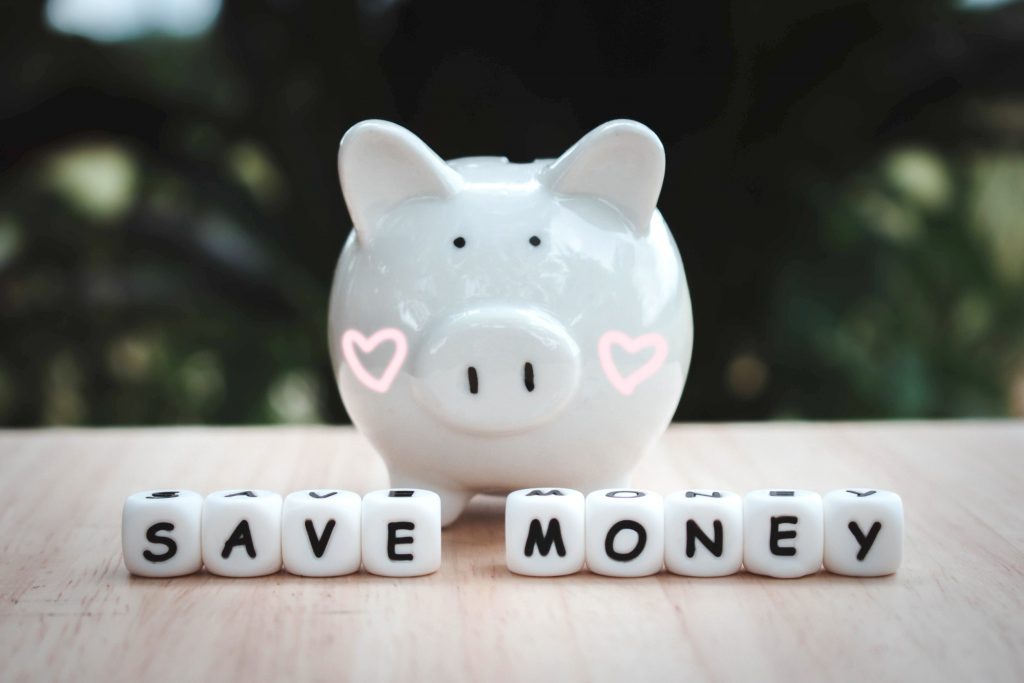 Dice the word "SAVE MONEY" and piggy bank money save coins. Block of alphabet studded on wooden background. money investment concept. Savings. Copy space.