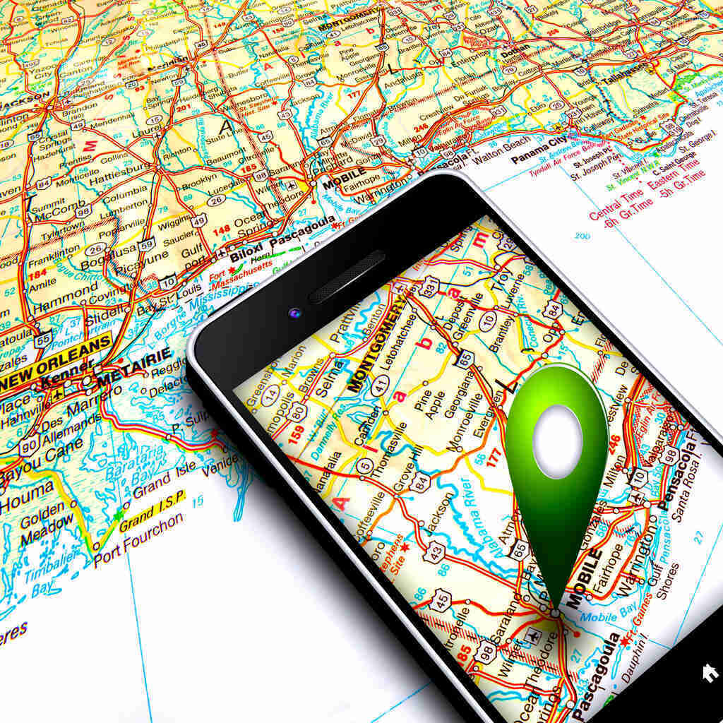Smartphone with GPS on display positioned on the map