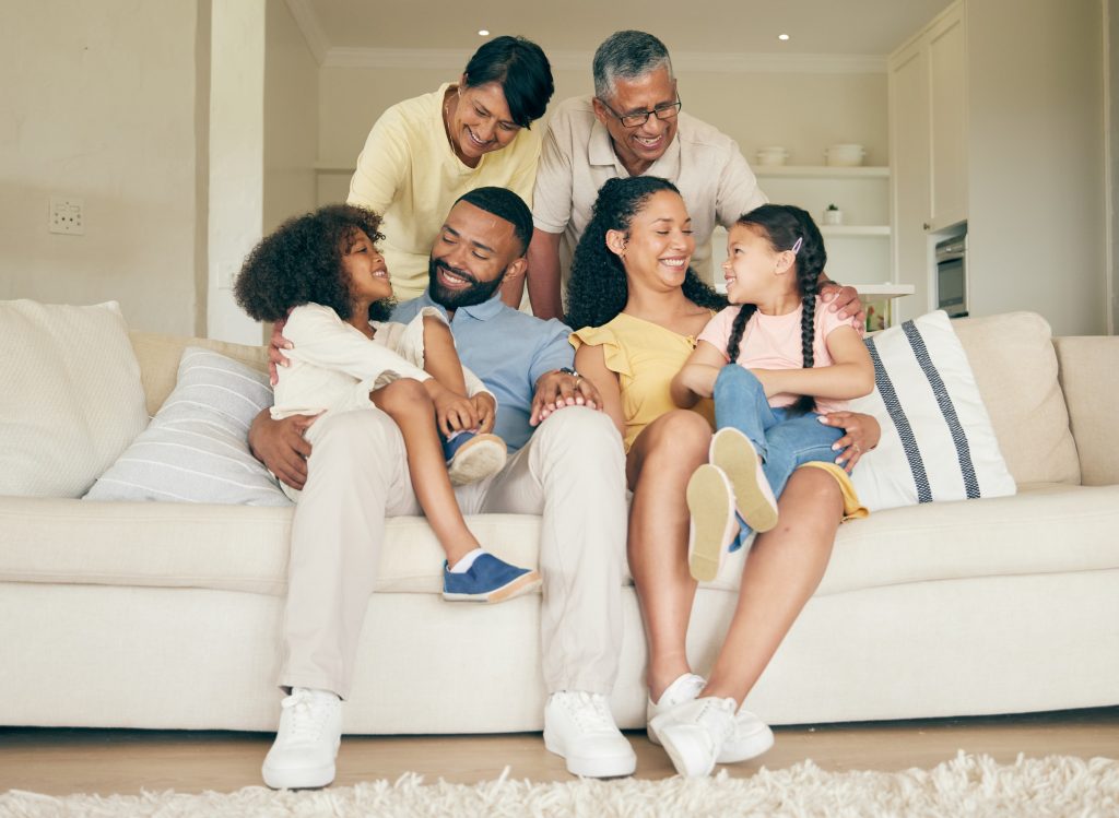 Grandparents, mother, father, and children, smiling and talking.