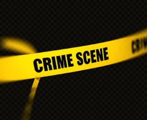 Yellow crime scene tape stretched diagonally across a dark background signaling a secured area